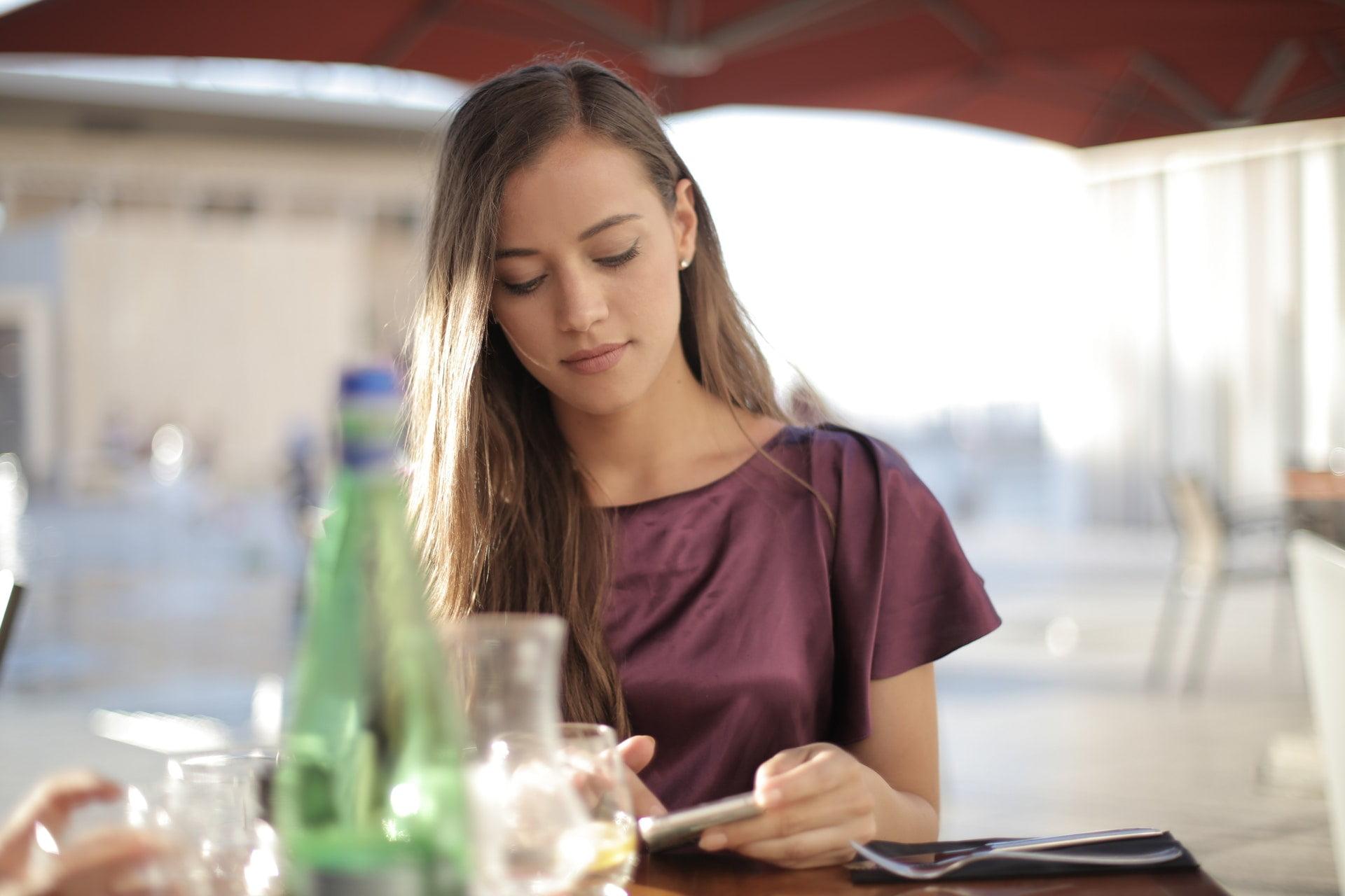 woman-in-purple-top-using-smartphone-3811582